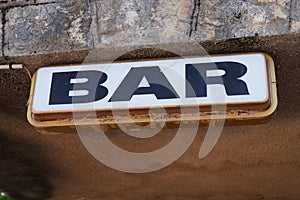 Text bar on facade wall front building entrance cafe pub in street