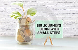 Text big journeys begin with small steps on note paper