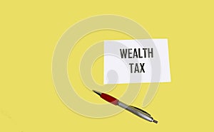 Text BIG TAX on a notepad and yellow background. Business concept