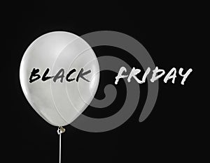 Text BLACK FRIDAY and white balloon on background
