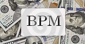 Text BPM on the dollars background, business concept