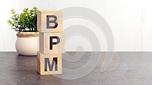 text BPM on wooden dice standing on top of each other