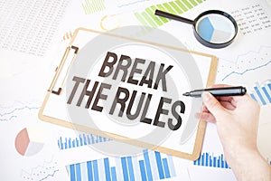 Text Break the Rule son white paper sheet and marker on businessman hand on the diagram. Business concept
