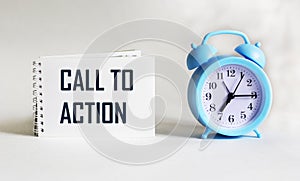 Text Call to Action on notepad and white background with clock. Conceptual image