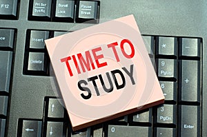 Text caption inspiration showing time to study. written time to study on sticky note paper on black keyboard background