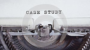 The text CASE STUDY is typed on paper by an antique typewriter. Vintage inscription, retro style, grunge, concept