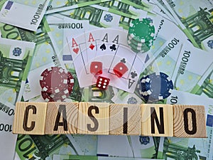 Text casino chips playing cards and dices on euro banknotes