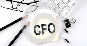 Text CFO on the sticker with keyboard , pencils and office tools