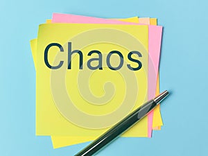 Text CHAOS written on sticky note.