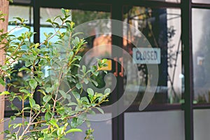 Text Closed door sign and hanging up on glass door