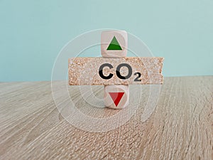 Text CO2 on brick block, cubes with arrow up down, concept of carbon reduction, Limiting global warming and mitigating climate