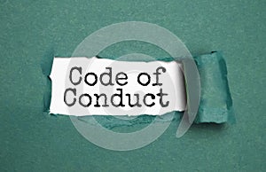 The text Code of conduct appearing behind torn brown paper