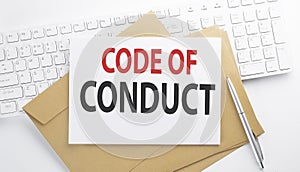 Text CODE OF CONDUCT on the envelope on the keyboard