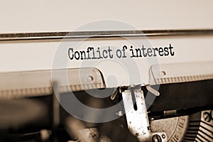 Text `conflict of interest` typed on retro typewriter. Business concept. Beautiful background. Copy space