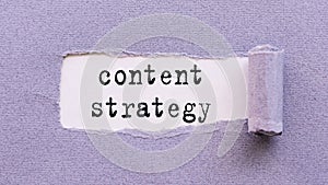 The text Content strategy appears on torn lilac paper against a white background