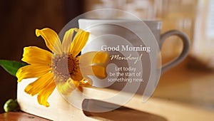 Text on a cup of coffee with flower - Good Morning Monday. Let today be the start of something new. Monday inspirational