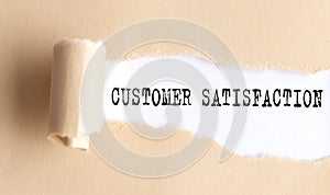 The text CUSTOMER SATISFACTION appears on torn paper on white background