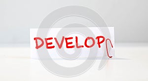text DEVELOP on white paper