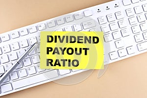 Text DIVIDEND PAYOUT RATIO text on a sticky on keyboard, business concept