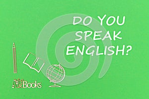 Text do you speak english, school supplies wooden miniatures on green background