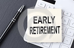 Text EARLY RETIREMENT on the sticker on the calculator, business concept