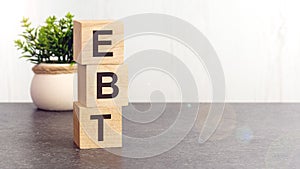 text EBT on wooden dice standing on top of each other