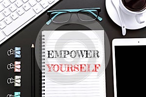 Text Empower yourself on white paper background / business concept