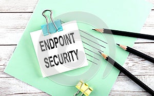 Text ENDPOINT SECURITY on the short note with pencils on the wooden background