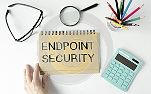 text Endpoint Security on yellow paper next to financial reports, calculator