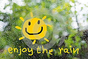A text `enjoy the rain` in concept to cheer up