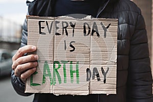 Text every day is Earth day in a brown signboard