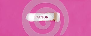 The text FACTOR appearing behind torn pink paper