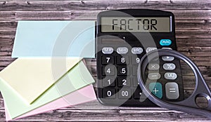 Text factor on a calculator, next to colored stickers