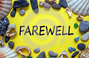 Text `farewell` on a beautiful yellow background. Sea stones and seashells. Concept