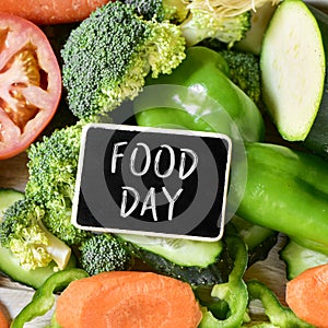 Text food day and raw vegetables