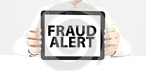Text fraud alert on tablet display in businessman hands on the white background. Business concept