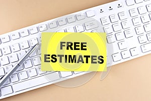 Text FREE ESTIMATES text on a sticky on keyboard, business concept