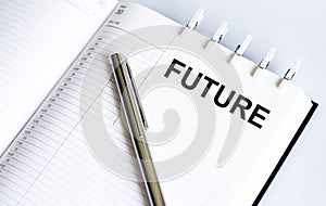 Text FUTURE on the short note texture background with pen