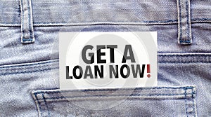 Text get a loan now on a white paper stuck out from jeans pocket. Business concept