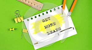 Text GET MORE LEADS sign showing on green background with office tools