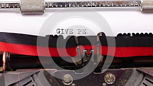 text GIVE PEACE A CHANGE written with vintage typewriter with black ink