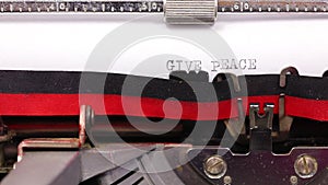 text GIVE PEACE A CHANGE written with a vintage typewriter with black ink