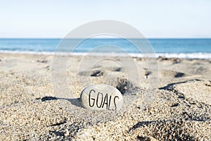 Text goals in a stone on the beach