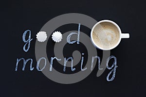Text Good morning with chalk on black background cup coffee and