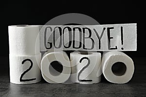 Text Goodbye 2020 made with toilet paper on grey stone background