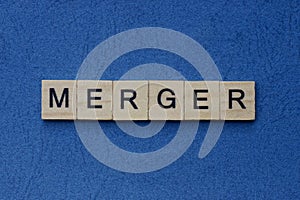 text on gray word merger in small wooden letters