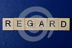 Text on gray word regard in small wooden letters
