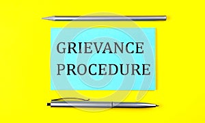 Text GRIEVANCE PROCEDURE on the blue sticker on the yellow background