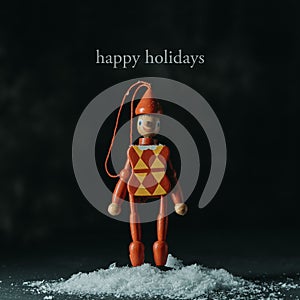 Text happy holidays and red christmas ornament