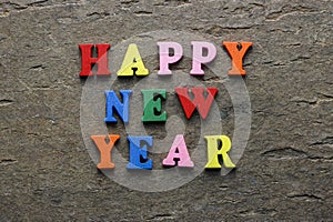 Text Happy New Year of bright multicolored wooden letters